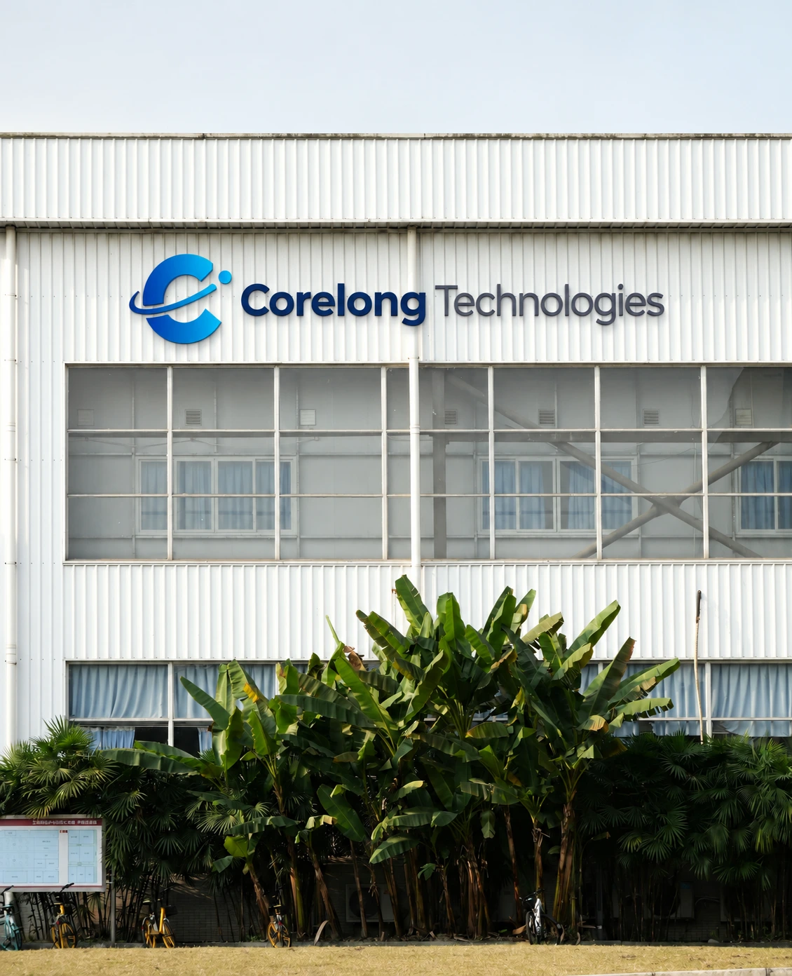 Real industrial-building stock photograph with composited CORELONG signage; brand illustration